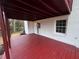 Enjoy outdoor living on this back porch, boasting dark-red trim, a white exterior, and space for chairs and tables at 4620 Central Dr, Stone Mountain, GA 30083