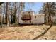 Backyard of home featuring upper and lower decks, trees, and partial fence at 4620 Central Dr, Stone Mountain, GA 30083