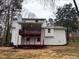 Exterior of home features large covered deck, brick, and mature trees at 4620 Central Dr, Stone Mountain, GA 30083