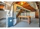 Unfinished basement features concrete floor, exposed ceiling with ductwork, workbench, and staircase at 4620 Central Dr, Stone Mountain, GA 30083