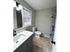 Modern bathroom with a new vanity, walk-in shower, updated fixtures, and neutral tile flooring at 4620 Central Dr, Stone Mountain, GA 30083