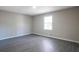 Bedroom with sleek gray hardwood floors, painted gray walls, and a bright white window at 4620 Central Dr, Stone Mountain, GA 30083