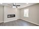 Cozy bedroom featuring a modern fireplace, ceiling fan, and a large window for natural light at 4620 Central Dr, Stone Mountain, GA 30083