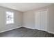 Bedroom with sleek gray hardwood floors, painted gray walls, and a bright white closet at 4620 Central Dr, Stone Mountain, GA 30083