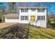 Charming two-story home with a well-manicured lawn, painted brick, and an inviting yellow front door at 4620 Central Dr, Stone Mountain, GA 30083