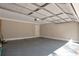 Spacious two car garage with neutral painted walls and grey sealed concrete floors at 4620 Central Dr, Stone Mountain, GA 30083