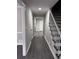 Hallway featuring new grey wood flooring, freshly painted walls and stairs at 4620 Central Dr, Stone Mountain, GA 30083