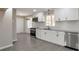 Modern kitchen featuring white cabinets, stainless steel appliances, and sleek countertops at 4620 Central Dr, Stone Mountain, GA 30083