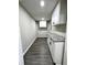 Laundry Room featuring new cabinets, granite countertops, stainless steel appliances, and new flooring at 4620 Central Dr, Stone Mountain, GA 30083