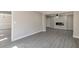 Spacious living room featuring a sleek fireplace, gray wood floors, and an open layout for versatile living at 4620 Central Dr, Stone Mountain, GA 30083