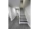 Staircase and open living area featuring new floors, neutral paint, and new baseboards at 4620 Central Dr, Stone Mountain, GA 30083