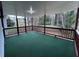 Inviting screened porch with green carpet and view of lush greenery, great for bug-free outdoor enjoyment at 4620 Central Dr, Stone Mountain, GA 30083