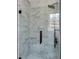 Modern bathroom shower featuring gray tiled walls and a sleek black shower head and handle at 4620 Central Dr, Stone Mountain, GA 30083