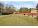 Large backyard with a well-maintained lawn, patio set, shed, and wooden fence at 5156 Olive Branch Cir, Powder Springs, GA 30127