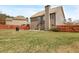 Spacious backyard featuring a patio set, well-maintained lawn, and view of the home's exterior at 5156 Olive Branch Cir, Powder Springs, GA 30127