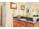 Bathroom with granite countertop, dark cabinets, framed wall art, and decorative towels at 5156 Olive Branch Cir, Powder Springs, GA 30127