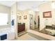 Bright bathroom with a soaking tub, dark wood vanity, and separate sinks at 5156 Olive Branch Cir, Powder Springs, GA 30127