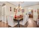 Traditional dining room with hardwood floors, chandelier, and views of the kitchen at 5156 Olive Branch Cir, Powder Springs, GA 30127