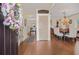 Inviting foyer featuring hardwood floors, elegant chandelier, and a glimpse of the dining area at 5156 Olive Branch Cir, Powder Springs, GA 30127
