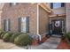 Close up showcasing the front door, flower wreath, and manicured landscaping in the front yard at 5156 Olive Branch Cir, Powder Springs, GA 30127