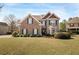 Charming two-story home featuring a well-manicured lawn and a mix of brick and siding accents at 5156 Olive Branch Cir, Powder Springs, GA 30127