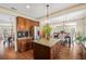 Spacious kitchen with stainless steel appliances, center island, and open layout to the dining and living areas at 5156 Olive Branch Cir, Powder Springs, GA 30127