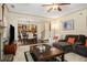 Open-concept living room showcasing hardwood floors, brick fireplace, and a view into the kitchen at 5156 Olive Branch Cir, Powder Springs, GA 30127