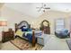 Spacious main bedroom with a vaulted ceiling, hardwood furniture, sitting area, and neutral decor at 5156 Olive Branch Cir, Powder Springs, GA 30127