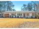 Charming home with white brick, wood shutters, well-manicured landscaping, and a neatly kept lawn at , Tucker, GA 30084