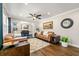 Cozy living room featuring hardwood floors, neutral walls, leather sofas, and bright natural lighting at 3515 Montreal Way, Tucker, GA 30084