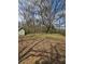 Spacious backyard with mature trees offering shade and privacy, ideal for outdoor activities at 2022 Cook Rd, Decatur, GA 30032