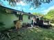 Back exterior of the home with fire damage and debris on the ground at 2022 Cook Rd, Decatur, GA 30032
