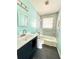 Bathroom with modern blue backsplash and vanity with white countertop and a shower and tub at 2022 Cook Rd, Decatur, GA 30032