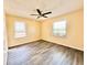 Bedroom featuring laminate wood flooring, yellow walls, and natural lighting at 2022 Cook Rd, Decatur, GA 30032