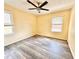 Bedroom featuring laminate wood flooring, yellow walls, and natural lighting at 2022 Cook Rd, Decatur, GA 30032