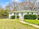 Charming home featuring a well-maintained front yard and mature shrubbery by entrance at 2022 Cook Rd, Decatur, GA 30032