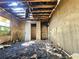 Interior view of the fire-damaged home with exposed ceiling and debris at 2022 Cook Rd, Decatur, GA 30032