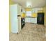 Features tile flooring, white cabinets, black refrigerator, and an electric range at 2022 Cook Rd, Decatur, GA 30032