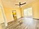 Living room featuring laminate wood flooring, yellow walls, and a sliding glass door at 2022 Cook Rd, Decatur, GA 30032