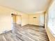 Living room featuring laminate wood flooring, yellow walls, and natural light from the window at 2022 Cook Rd, Decatur, GA 30032