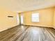 Living room featuring laminate wood flooring, yellow walls, and a glass door at 2022 Cook Rd, Decatur, GA 30032