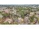 An aerial view of the property, showcasing its spacious lot, surrounding trees, and proximity to a pond at 65 Deer Run Ln, Mcdonough, GA 30252