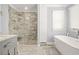 Bright bathroom with a glass door shower, soaking tub, and neutral paint at 65 Deer Run Ln, Mcdonough, GA 30252