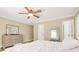 Bedroom featuring hardwood floors, ceiling fan, and large windows with a neutral color scheme at 65 Deer Run Ln, Mcdonough, GA 30252