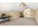 Large bonus room with carpeted floor and featuring a ceiling fan and french doors at 65 Deer Run Ln, Mcdonough, GA 30252
