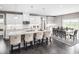 Modern kitchen with white cabinetry, granite countertops, stainless steel appliances, and adjacent dining area at , Locust Grove, GA 30248