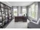 Bright office space featuring large windows, dark wood floors, bookshelves, and gray decor at , Locust Grove, GA 30248