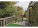 Inviting back porch featuring wood flooring, stylish railing, and decorative exterior lighting, ideal for relaxing outdoors at 1000 Bozeman Dr, Atlanta, GA 30341