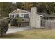 Cozy home featuring a side entrance, backyard access, and a well-kept yard at 1000 Bozeman Dr, Atlanta, GA 30341