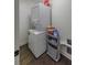Stacked washer and dryer with storage in the laundry area at 1000 Bozeman Dr, Atlanta, GA 30341